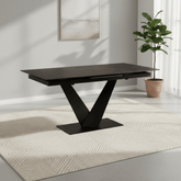 Adam extending dining table with black sintered stone top, V-shaped pedestal base and easy extension mechanism. Seats 4 to 8 people.