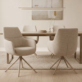 Two beige armchairs with wooden legs on a white background