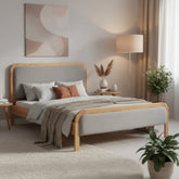 Wooden bed with linen upholstered headboard and softly curved frame.