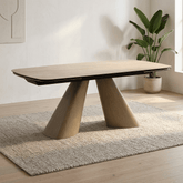 A modern rectangular dining table with a Cream Ceramic top and Light Oak angled pedestal legs, shown in a Living Room