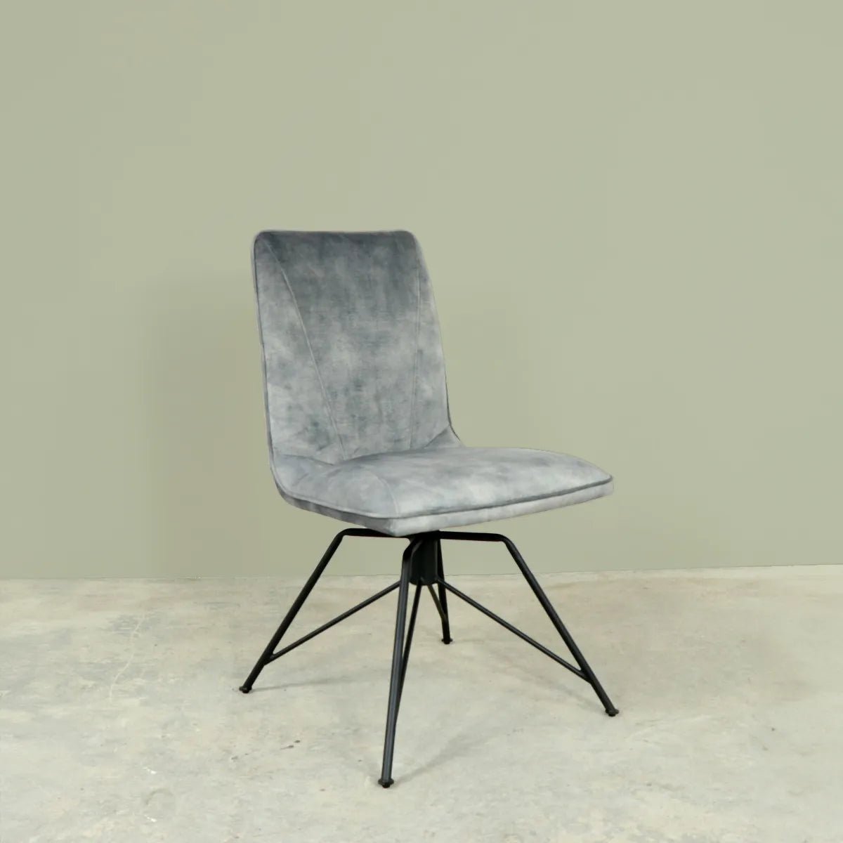 Gray upholstered chair with black metal legs on a light gray background