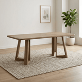 Shop the Cara 200cm Smokey Oak Effect Dining Table. Featuring a spacious rectangular top, rounded corners and sculptural architectural base.