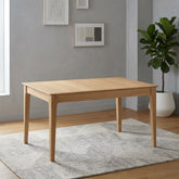 A light natural oak rectangular dining table with four tapered legs, shown from a three-quarter angle on a solid white background.