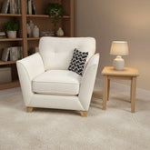 Joshua Matera fabric armchair with deep seating and wooden legs.