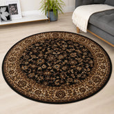 Black round rug with traditional Beluchi pattern design.