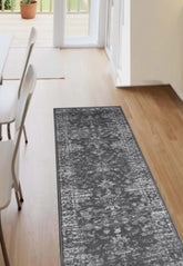 Charcoal runner rug with traditional pattern and durable polypropylene fabric.