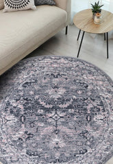 Round grey rug with traditional inspired pattern.