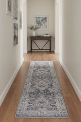 Grey runner rug with traditional inspired pattern.