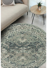 Round sage green rug with traditional inspired pattern.