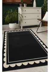 Black rug with stylish scallop inspired pattern design.