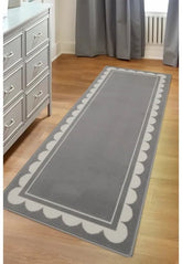 Grey runner rug with stylish scallop pattern design.