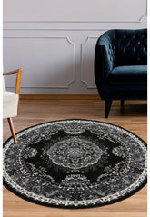 Round black and grey rug with geometric pattern design.