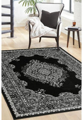 Black and grey rug with bold geometric pattern design.