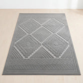 Grey rug with tribal inspired pattern and modern design.