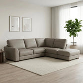 Large L-shaped leather sofa with supportive cushions and elegant finish.