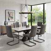 A modern dining room set featuring Monza Marble Extending Dining Table with Cuneo Grey Faux Leather Chairs