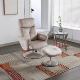 A beige upholstered recliner chair with a matching ottoman are shown in a bright, modern living room setting with a patterned area rug, a small glass-top side table, and window blinds.