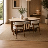 Portofino 180cm dining table with a luxurious natural stone top, sculptural walnut-effect base and rounded edges styled with 4 Dining Chairs in a Room