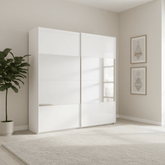Modern Rauch forms White Glass and Mirror sliding wardrobe with glass doors in a minimalistic room.