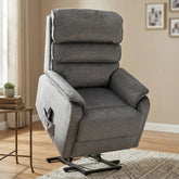 A gray upholstered recliner chair with a tall segmented backrest, padded armrests, and a black metal swivel base, shown in a styled living room setting.