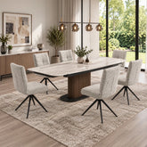 A modern dining room setup featuring a rectangular Umbria Travertine Ceramic Dining Table with Swivel Armless Chairs