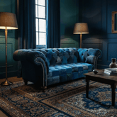 Blue patchwork sofa in a room with dark blue walls, a patterned rug, and a wooden coffee table.