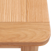 Close-up detail of a Chatsworth Oak Extending Dining Table corner, showing the rounded edge, tabletop grain, and part of the leg on a white background.