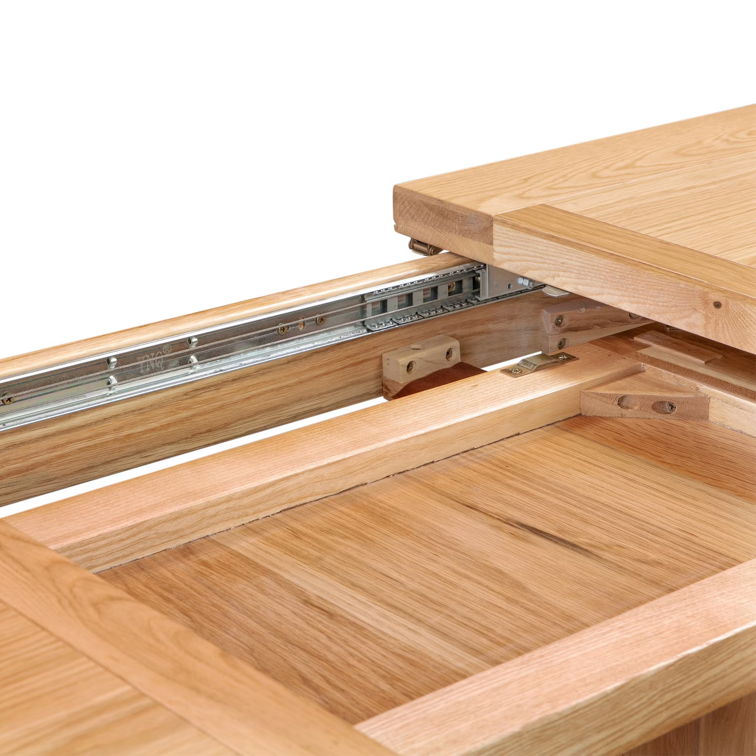 Close-up of a Chatsworth Oak Extending Dining Table with a lift-top section raised, showing metal drawer or cabinet pull hardware and the interior wood structure against a white background.