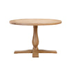 A round wooden dining table with a pedestal base and cross-style feet, shown on a plain white background.
