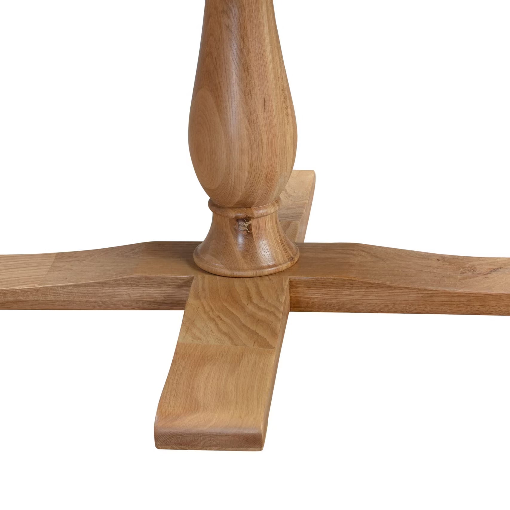 Close-up of a turned wooden table leg centered on a cross-shaped base with a visible wood grain pattern of Chatsworth Oak Round Dining Table 120cm