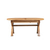 An oval wooden dining table with a natural light brown finish, featuring a central seam on the tabletop and a sturdy crossbar support, shown against a plain white background.
