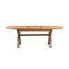 An oval wooden dining table with a natural light brown finish, featuring a central stretcher support and angled legs, shown against a plain white background.