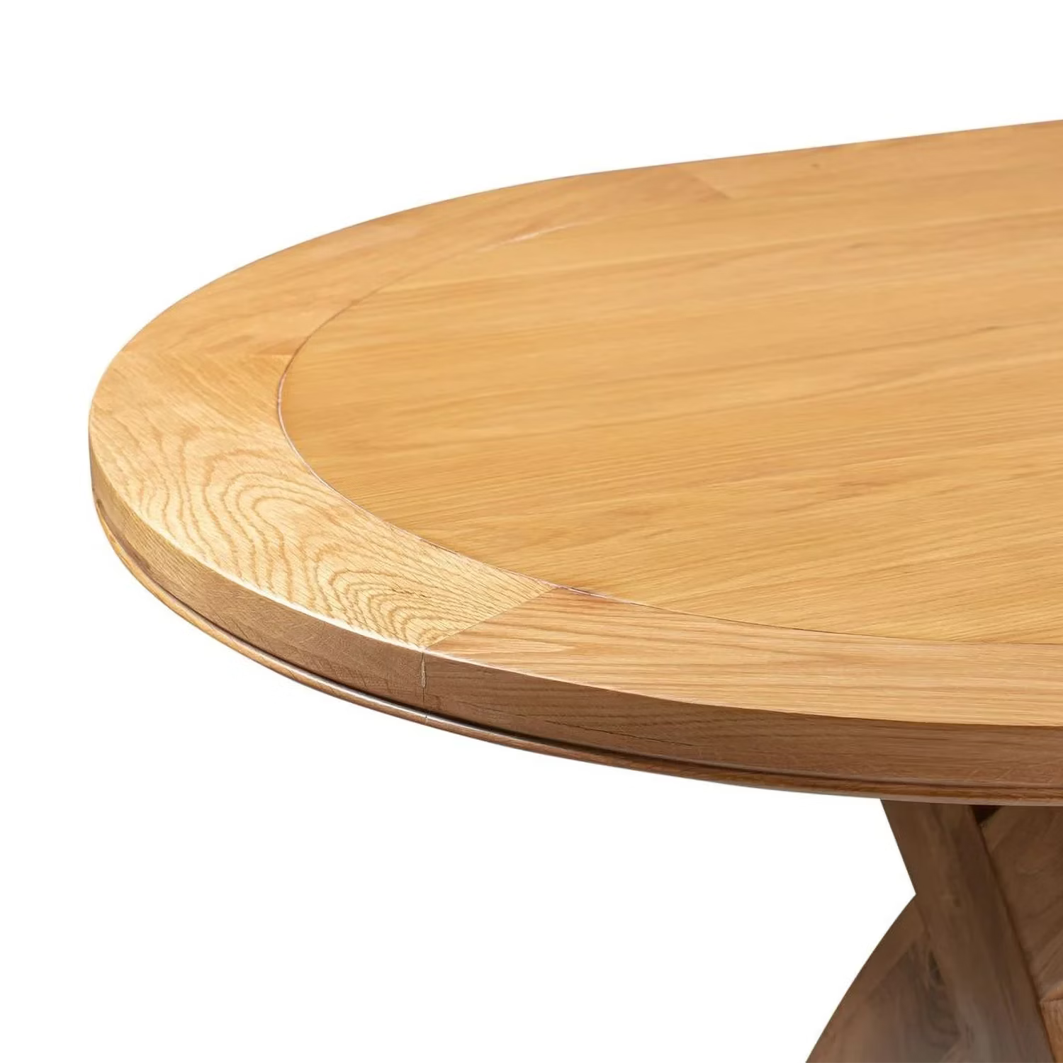 Close-up of a light oak Chatsworth Oak Oval Extending Cross Leg Dining Table showing the curved tabletop edge, wood grain, and part of the pedestal base against a white background.
