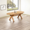 Shop the Chatsworth oak oval extending dining table. Features a butterfly extension, sculptural cross-leg pedestal base and natural oak finish.