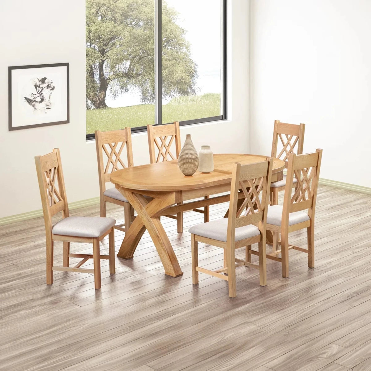 A 7-piece round wooden dining table set with six matching chairs featuring light beige upholstered seats, shown in a bright dining room with wood-look flooring and a large window.