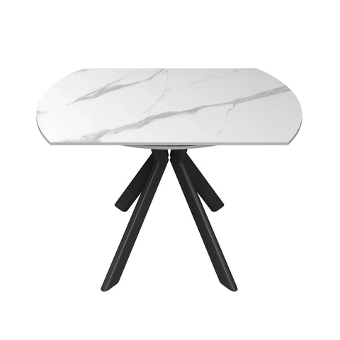 A modern dining table with a white marble effect sintered stone patterned oval top and three black angled legs, shown on a plain white background.