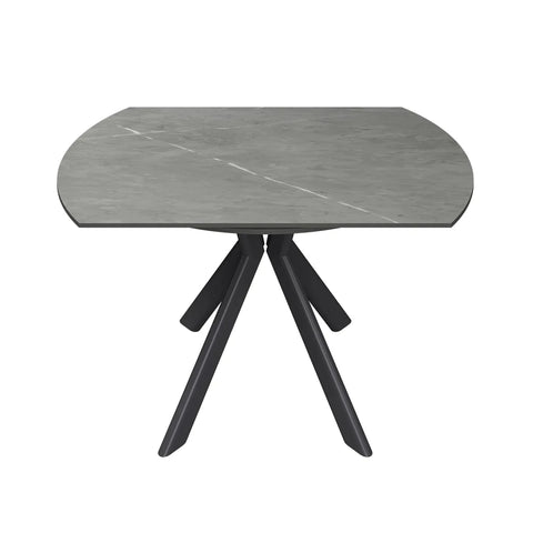 A modern semi-circular dining table with a gray stone-look top and a black three-legged metal base, shown against a plain white background.