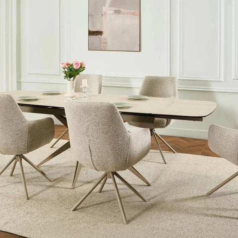 Dining room with a round table and chairs in a modern interior setting.