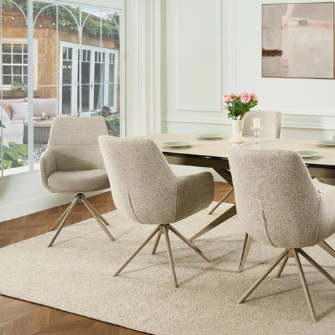 Modern dining room with beige chairs and a round table.