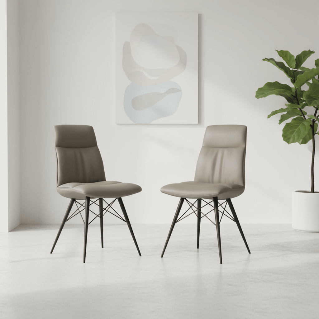 Two upholstered dining chairs in taupe with black metal wire legs, shown in a bright minimalist room with a potted plant and abstract wall art.