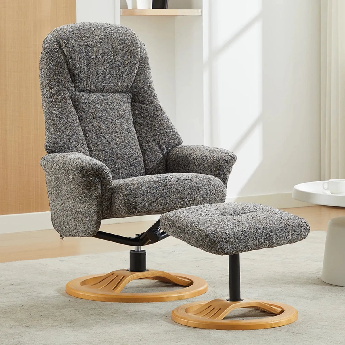 Grey recliner chair with wooden base in a room setting