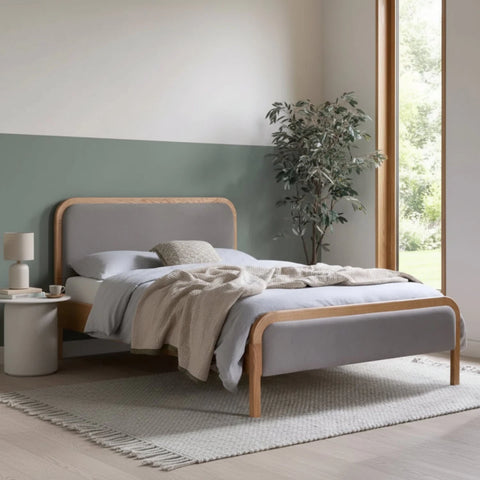 Contemporary bed with soft linen upholstery and natural wood design.