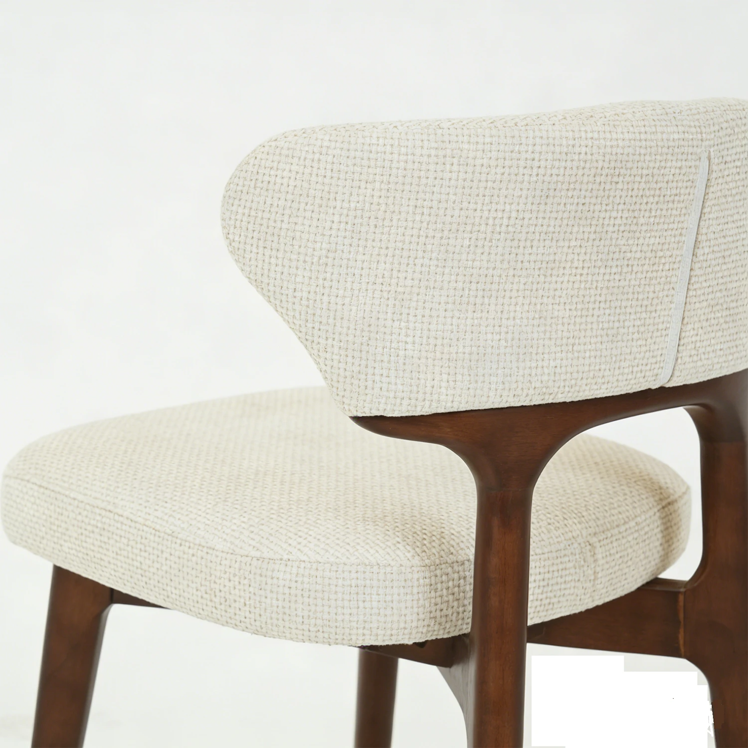 Chair with beige cushioned seat and backrest on a white background