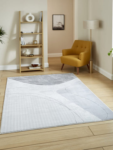 Apollo E9974 Modern Abstract Rug in Grey Silver styled in a modern room
