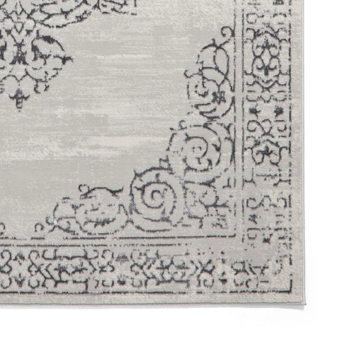 Close-up of a patterned rug with intricate designs on a white background