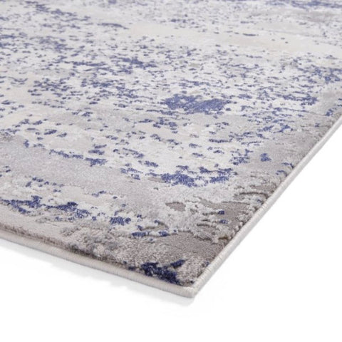 Gray and blue patterned rug on a white background