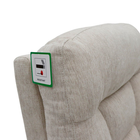Beige upholstered chair with a label indicating fire resistance on a white background