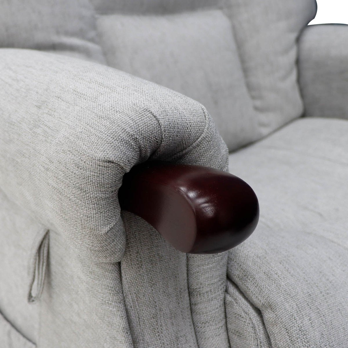 Close-up of a gray Astoria Rise and recline armchair with a brown armrest.