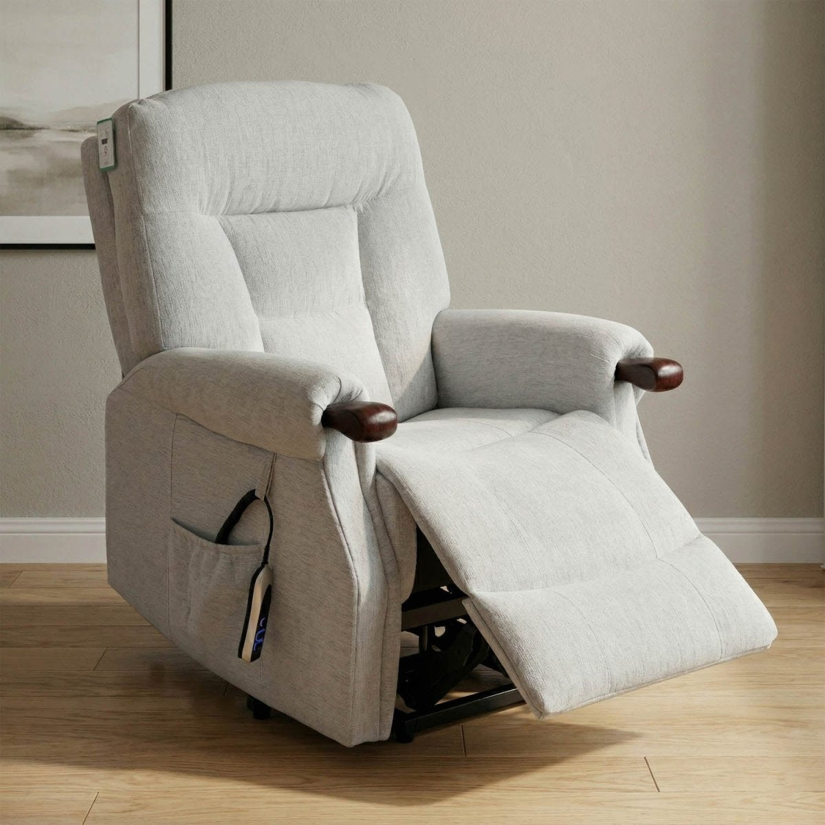 A light gray upholstered recliner chair with the seat extended, shown in a real indoor room with wood flooring and a neutral wall.