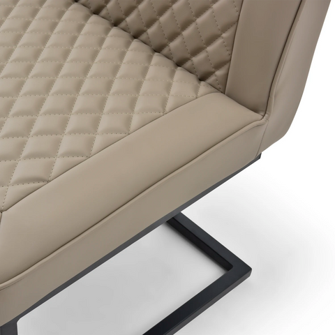 Close-up of a beige quilted dining bench with a black metal frame. Matching items available 